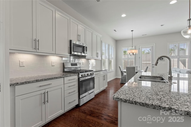 kitchen featuring recessed lighting, appliances with stainless steel finishes, white cabinetry, and a sink