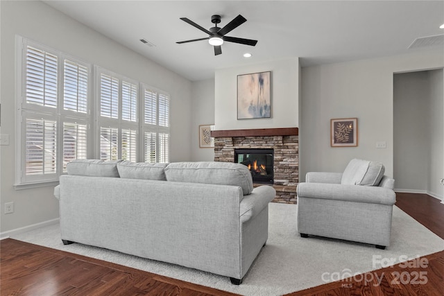 living area featuring a healthy amount of sunlight, baseboards, and visible vents