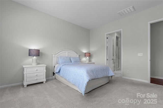 bedroom with baseboards, light colored carpet, connected bathroom, and visible vents