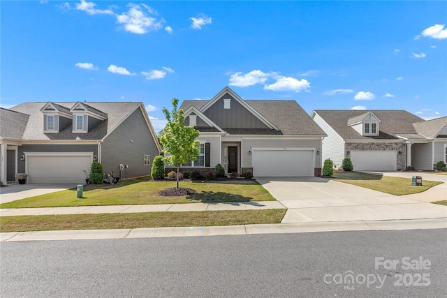 view of front of home featuring board and batten siding, driveway, a front lawn, an attached garage, and a shingled roof