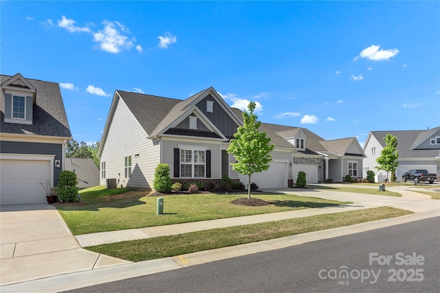 view of front of house with a front lawn, a garage, board and batten siding, central air condition unit, and driveway