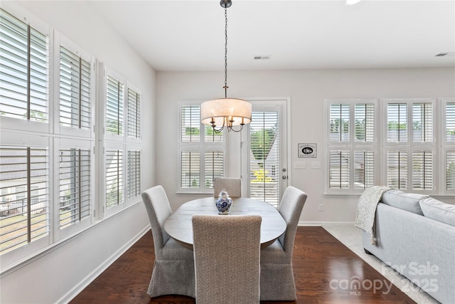329 Brambling Ct, Wesley Chapel, NC 28110 - dining space featuring healthy amount of natural light, a chandelier, baseboards, and dark wood-style flooring