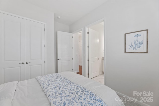 329 Brambling Ct, Wesley Chapel, NC 28110 - bedroom featuring baseboards, a closet, and ensuite bath