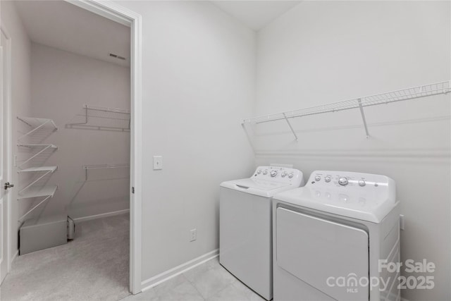 329 Brambling Ct, Wesley Chapel, NC 28110 - laundry area featuring washing machine and clothes dryer and baseboards