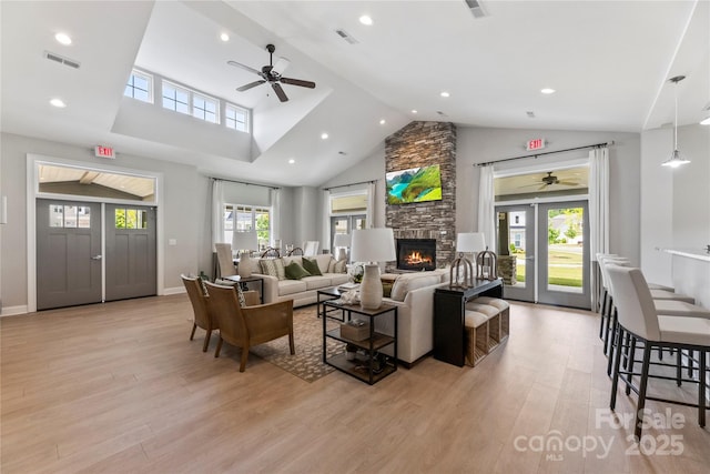 329 Brambling Ct, Wesley Chapel, NC 28110 - living room featuring a ceiling fan, light wood-type flooring, a fireplace, recessed lighting, and high vaulted ceiling