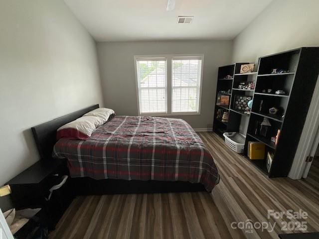 bedroom featuring visible vents and wood finished floors