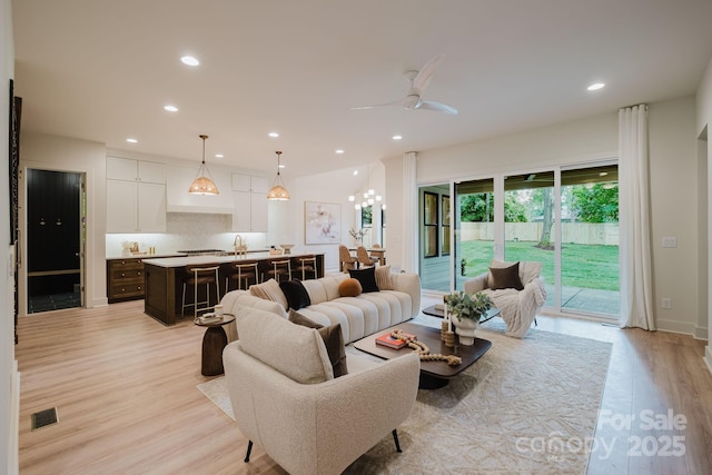 1807 Arnold Dr, Charlotte, NC 28205 - living area with light wood finished floors, ceiling fan, and recessed lighting