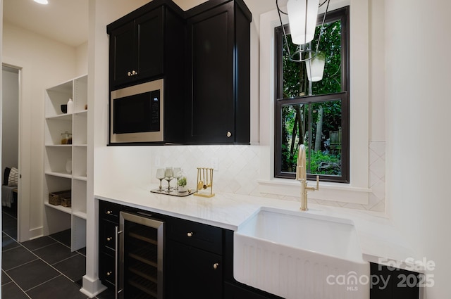 1807 Arnold Dr, Charlotte, NC 28205 - bar area featuring built in microwave, healthy amount of natural light, a sink, and dark tile patterned flooring