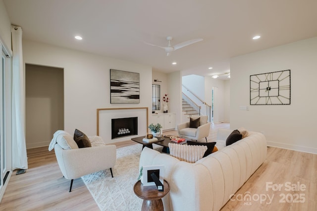 1807 Arnold Dr, Charlotte, NC 28205 - living room featuring light wood-style floors, stairs, a fireplace, recessed lighting, and baseboards