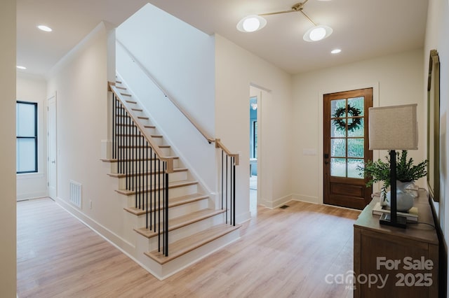 1807 Arnold Dr, Charlotte, NC 28205 - foyer entrance featuring light wood-type flooring, stairway, baseboards, and recessed lighting