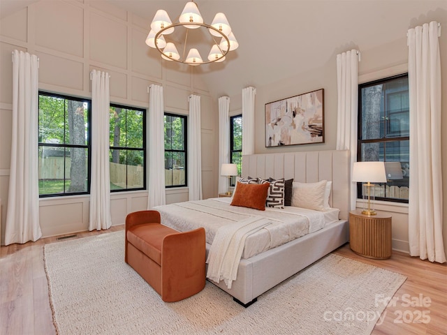 1807 Arnold Dr, Charlotte, NC 28205 - bedroom with a chandelier, multiple windows, and wood finished floors