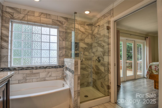 bathroom featuring ornamental molding, a stall shower, and plenty of natural light
