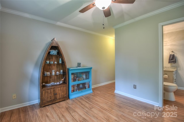 interior space with crown molding, wood finished floors, and baseboards