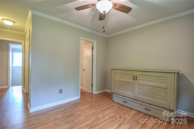 unfurnished bedroom featuring crown molding, ceiling fan, baseboards, and light wood-type flooring