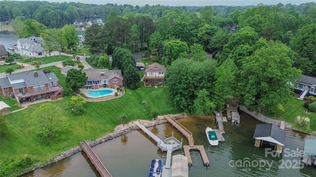 bird's eye view featuring a wooded view and a water view