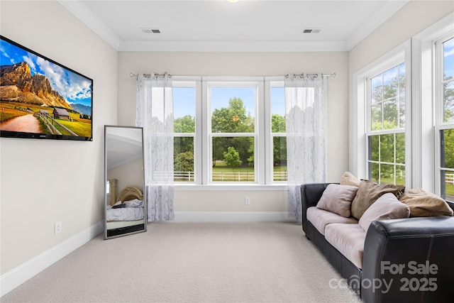 sitting room featuring carpet floors, crown molding, baseboards, and visible vents