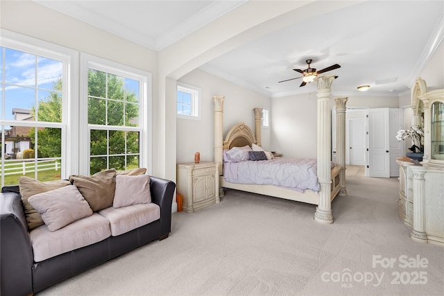 bedroom with light carpet, ornamental molding, and a ceiling fan