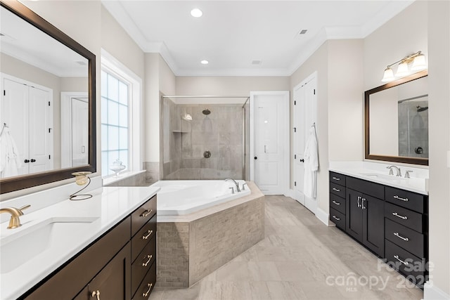 full bath with a sink, ornamental molding, a stall shower, two vanities, and a garden tub