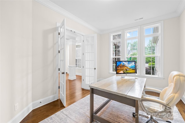 office with crown molding, wood finished floors, visible vents, and french doors