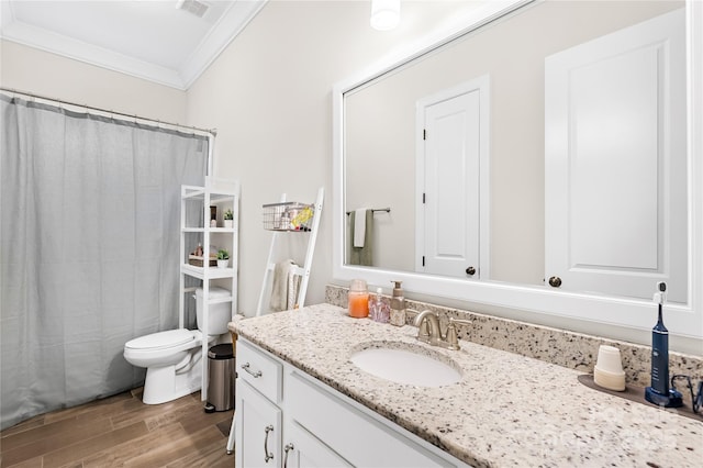 full bath featuring toilet, wood finished floors, vanity, visible vents, and crown molding