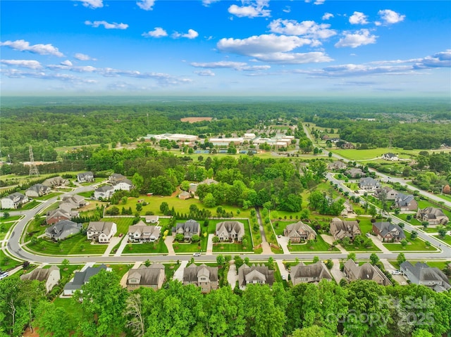 drone / aerial view featuring a view of trees and a residential view