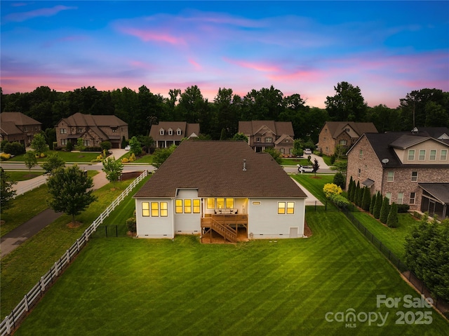 rear view of house featuring a residential view, a deck, and fence private yard