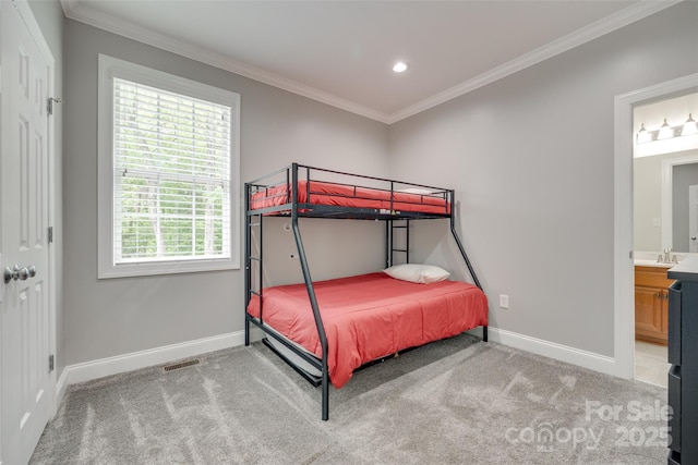 carpeted bedroom with ensuite bathroom, visible vents, baseboards, ornamental molding, and recessed lighting