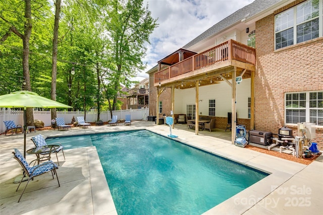 view of pool with a patio, a fenced in pool, a fenced backyard, and a deck