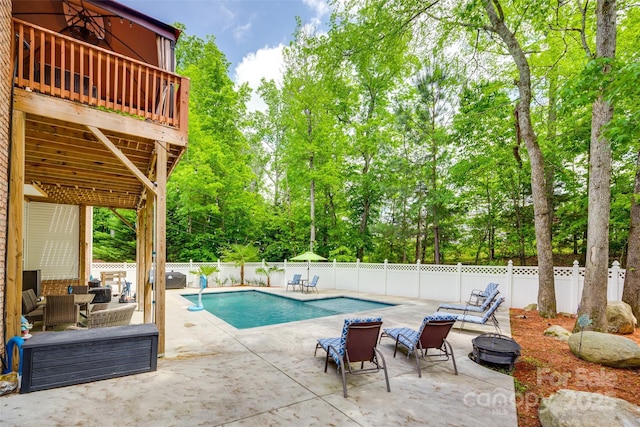 view of swimming pool featuring a patio, a fenced backyard, an outdoor living space with a fire pit, and a fenced in pool