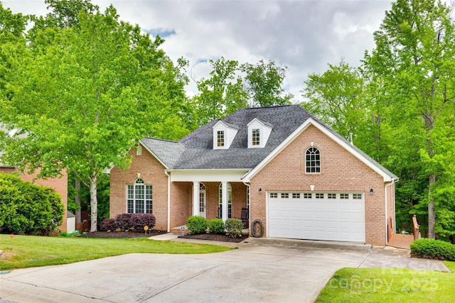 view of front facade with roof with shingles, a front lawn, brick siding, a garage, and concrete driveway