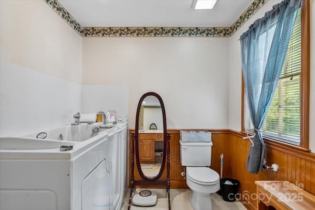 1044 Oakridge Farm Hwy, Mooresville, NC 28115 - bathroom featuring toilet, wainscoting, wood walls, and plenty of natural light