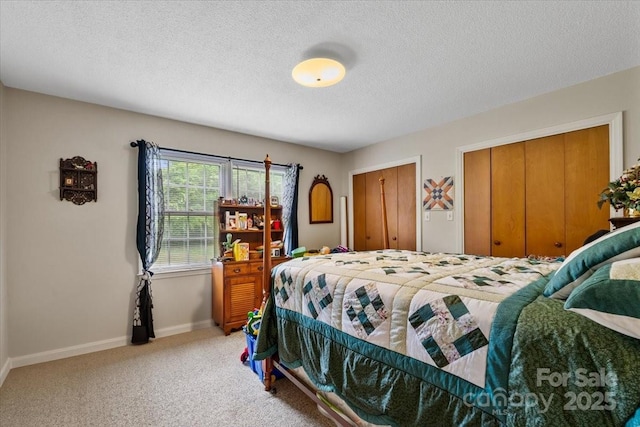 1044 Oakridge Farm Hwy, Mooresville, NC 28115 - bedroom with a textured ceiling, multiple closets, light colored carpet, and baseboards