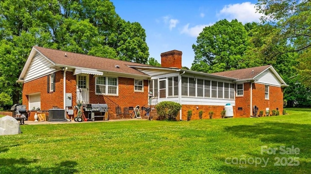 1044 Oakridge Farm Hwy, Mooresville, NC 28115 - back of house with a chimney, brick siding, a garage, a sunroom, and a lawn