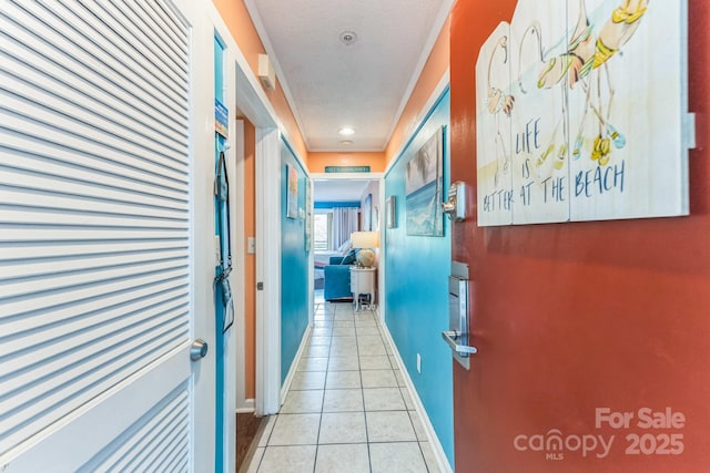 415 Ocean Creek Dr N Unit 2330, Myrtle Beach, SC 29572 - hallway featuring light tile patterned floors, a textured ceiling, and baseboards