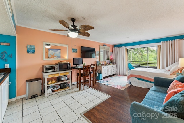 415 Ocean Creek Dr N Unit 2330, Myrtle Beach, SC 29572 - bedroom with a textured ceiling, ornamental molding, light wood-style floors, and baseboards