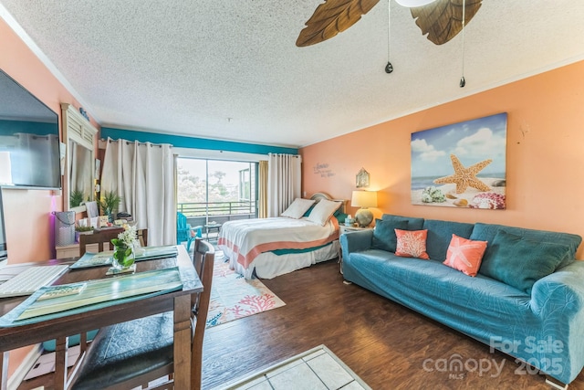 415 Ocean Creek Dr N Unit 2330, Myrtle Beach, SC 29572 - bedroom with a textured ceiling, wood finished floors, and ceiling fan