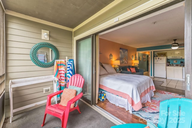415 Ocean Creek Dr N Unit 2330, Myrtle Beach, SC 29572 - bedroom featuring freestanding refrigerator and wood walls