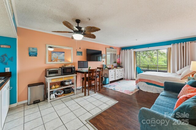 415 Ocean Creek Dr N Unit 2330, Myrtle Beach, SC 29572 - bedroom featuring a textured ceiling, ornamental molding, and light wood finished floors