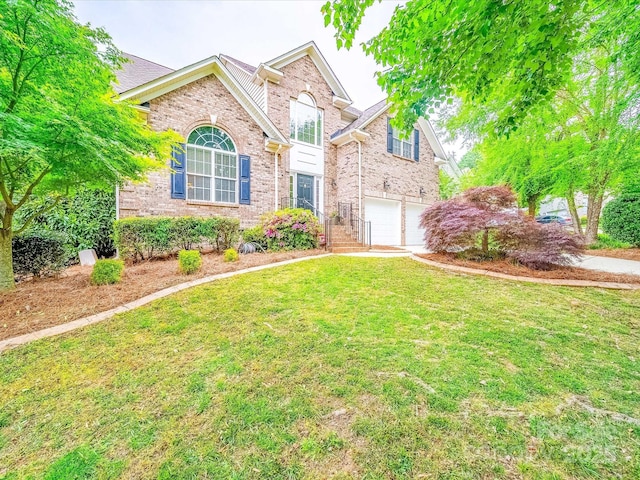 traditional home with a garage, brick siding, and a front yard