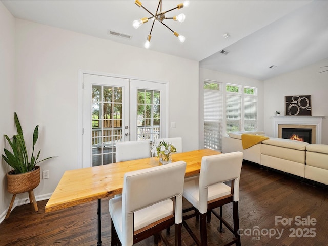 dining area with french doors, visible vents, a wealth of natural light, and dark wood-style flooring