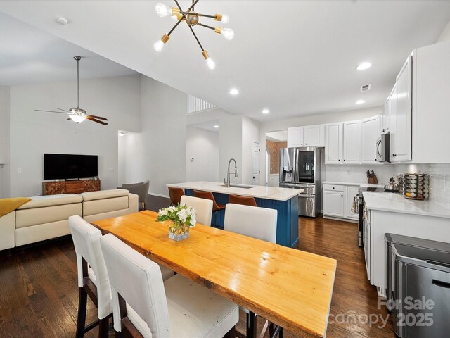 dining space with visible vents, recessed lighting, dark wood-style floors, and ceiling fan with notable chandelier