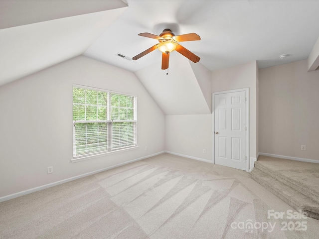bonus room with ceiling fan, vaulted ceiling, carpet floors, and baseboards