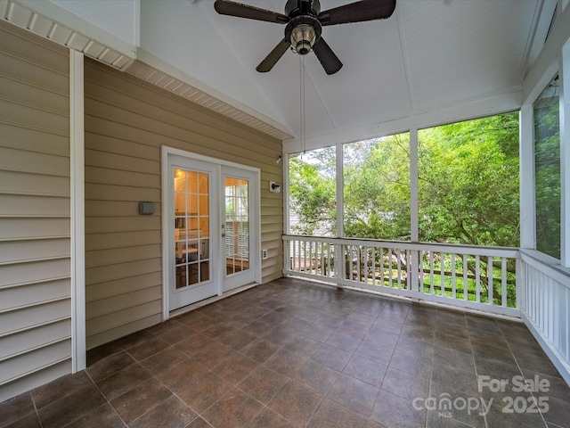 unfurnished sunroom featuring a ceiling fan