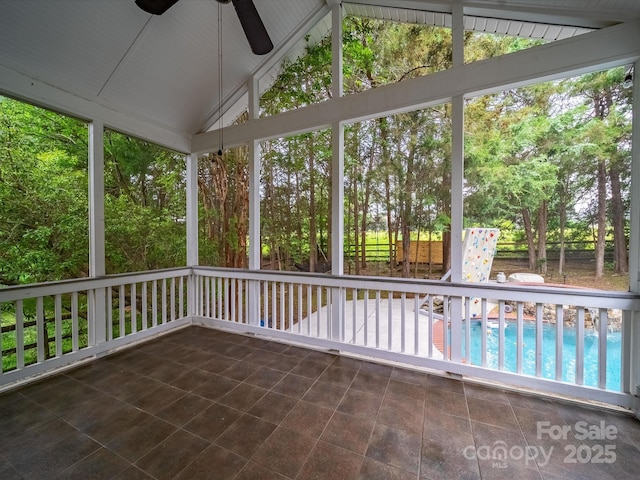 unfurnished sunroom with ceiling fan and plenty of natural light