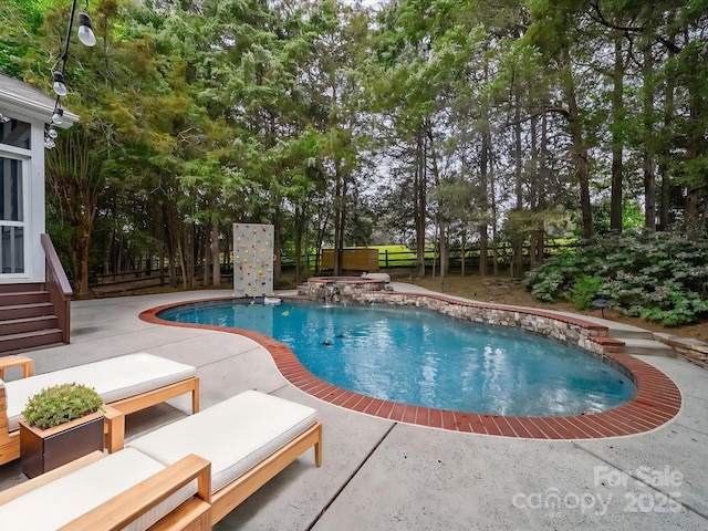 outdoor pool with an in ground hot tub, a patio, and fence private yard