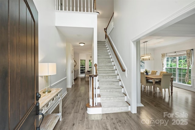 6723 Joliette Ln, Charlotte, NC 28277 - foyer entrance featuring stairs, wood finished floors, crown molding, a chandelier, and baseboards