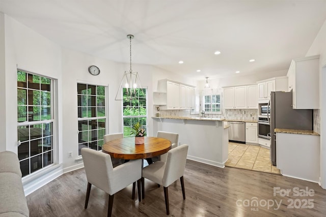 6723 Joliette Ln, Charlotte, NC 28277 - dining space with light wood-style flooring and recessed lighting