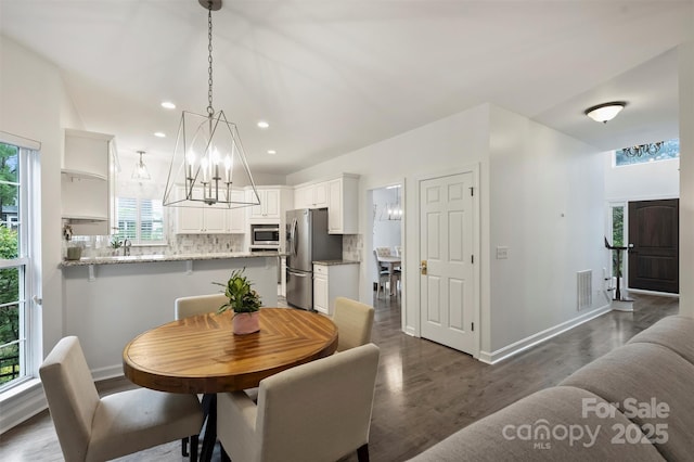6723 Joliette Ln, Charlotte, NC 28277 - dining space featuring a chandelier, dark wood finished floors, baseboards, and recessed lighting