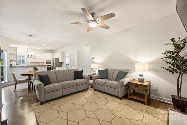 6723 Joliette Ln, Charlotte, NC 28277 - living area with light wood-style floors, ceiling fan, recessed lighting, baseboards, and a chandelier