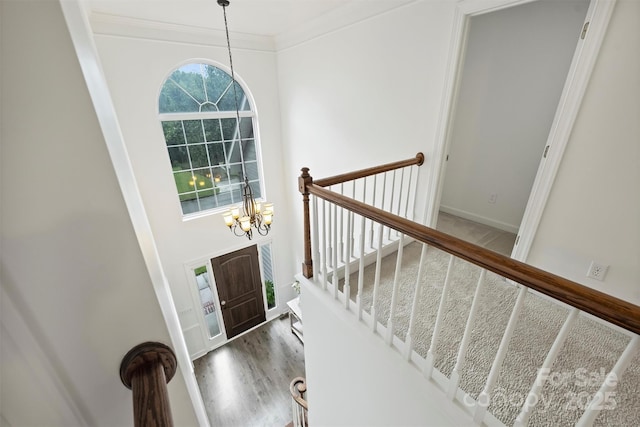 6723 Joliette Ln, Charlotte, NC 28277 - foyer featuring a chandelier, crown molding, wood finished floors, and stairway